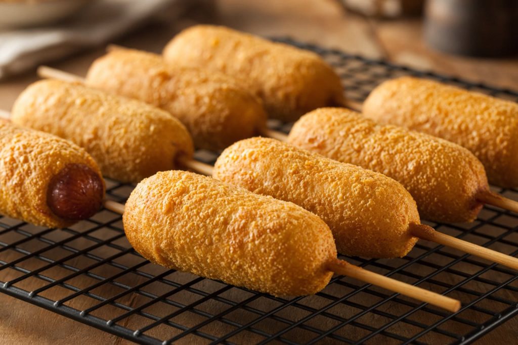Corn dogs on a rack