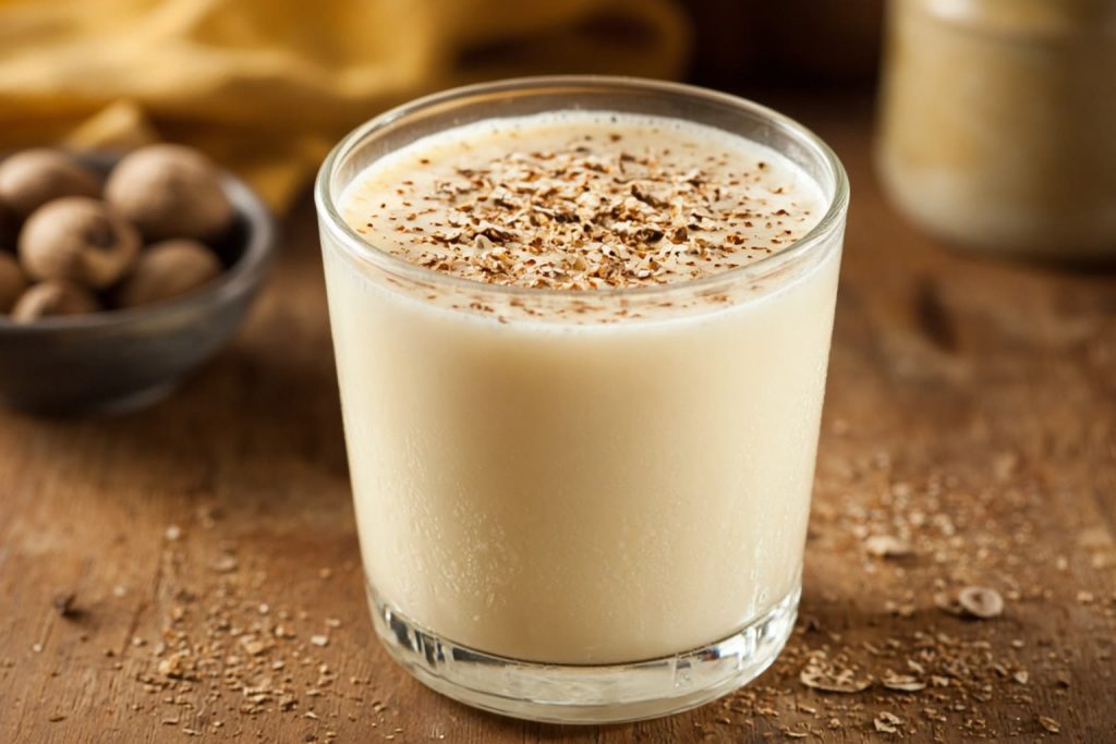 Eggnog in a glass with nutmeg